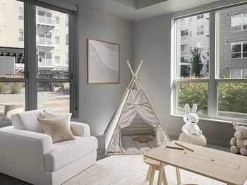 a living room with a teepee and a couch and a coffee table